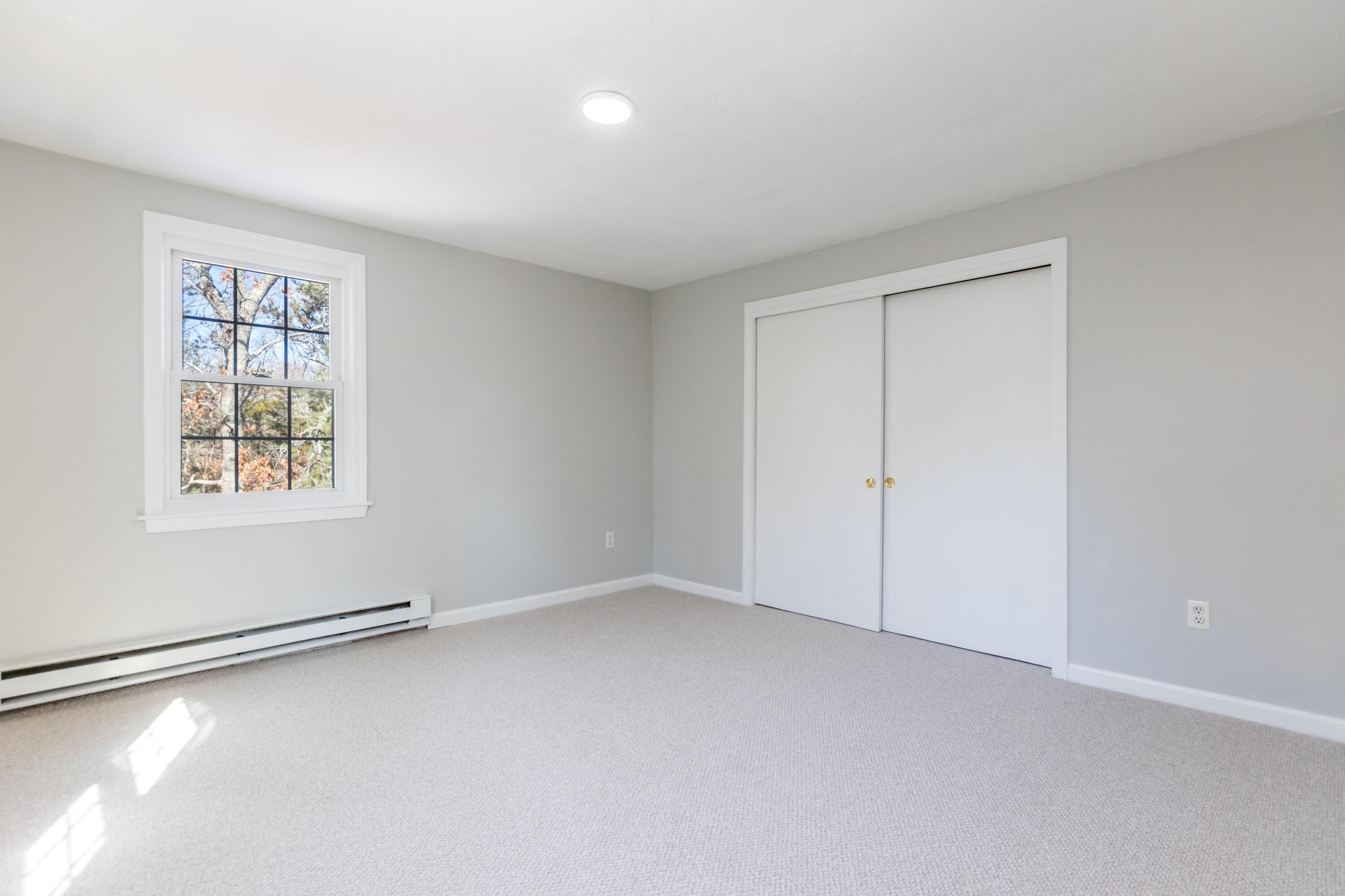 300 Falmouth Road, Unit 16A Mashpee, MA 02649 - Photo 19 of 25 an empty room with windows