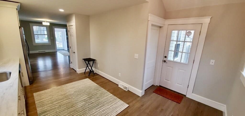 60 Grove Street Barnstable, MA 02601 - Photo 11 of 34 a view of a hallway with wooden floor and staircase