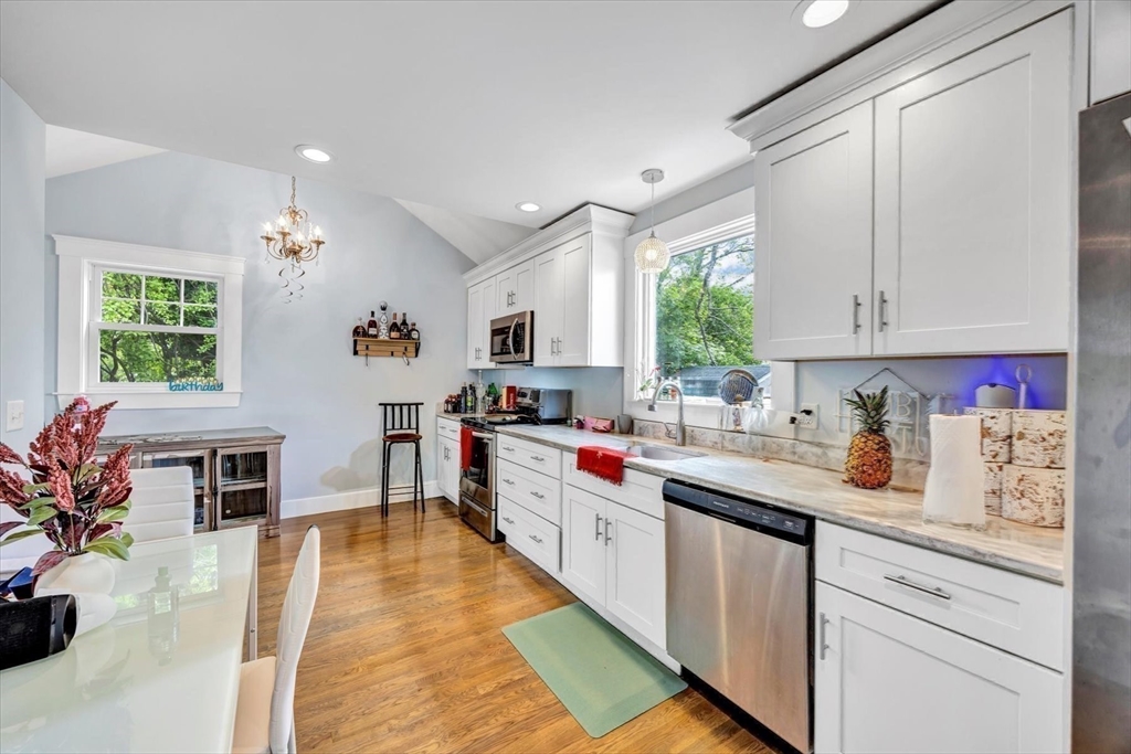 60 Grove Street Barnstable, MA 02601 - Photo 19 of 34 a kitchen with kitchen island granite countertop a sink cabinets stainless steel appliances and a window