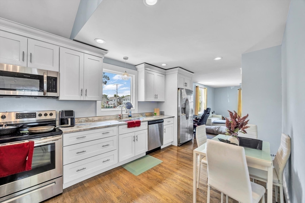 60 Grove Street Barnstable, MA 02601 - Photo 21 of 34 a kitchen with stainless steel appliances kitchen island granite countertop a stove and white cabinets
