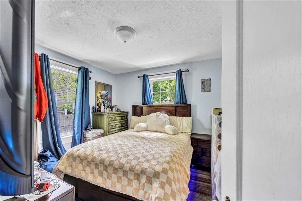 60 Grove Street Barnstable, MA 02601 - Photo 25 of 34 a bedroom with a large bed and a flat tv screen on dresser