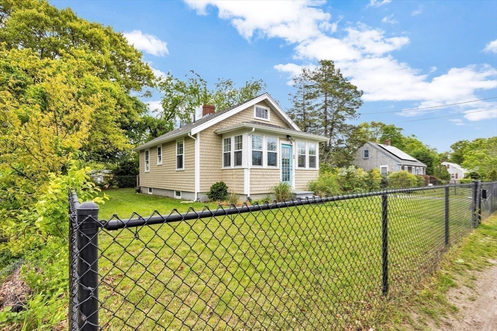 60 Grove Street Barnstable, MA 02601 - Photo 30 of 34 a view of a house with a wooden fence