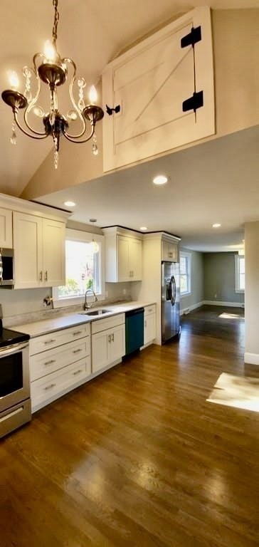 60 Grove Street Barnstable, MA 02601 - Photo 4 of 34 a large white kitchen with a stove a sink and a fireplace