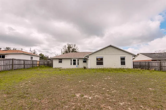 a view of a house with a yard and plants