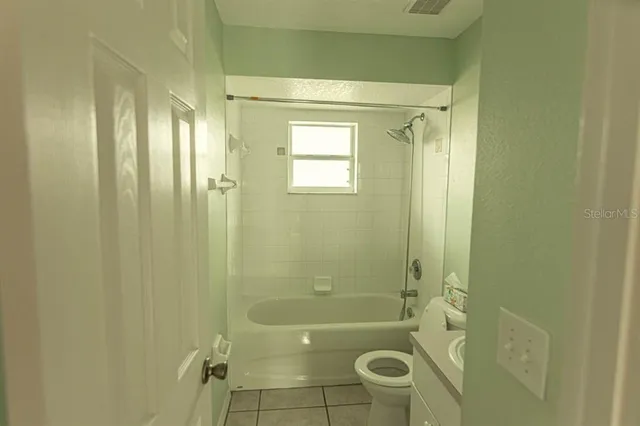 a bathroom with a shower and a toilet