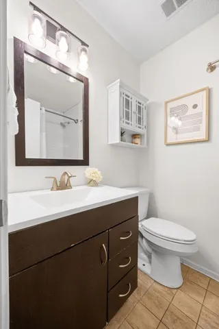 a bathroom with a toilet a sink and mirror