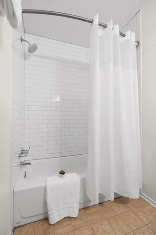 a bathroom with a shower curtain and a sink