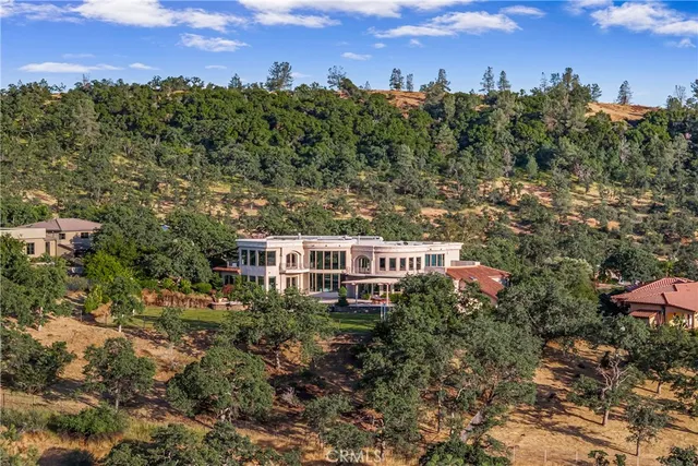 an aerial view of a house with yard swimming pool and outdoor seating