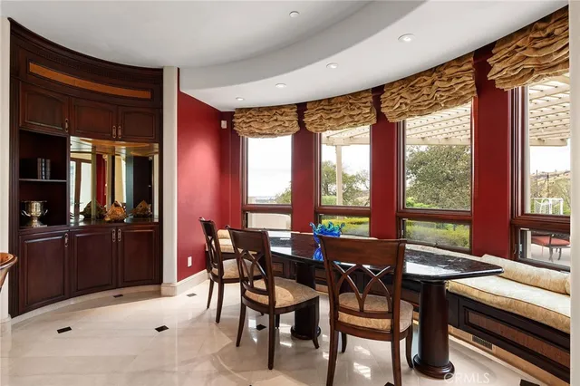 a large bed sitting in a bedroom next to a large window