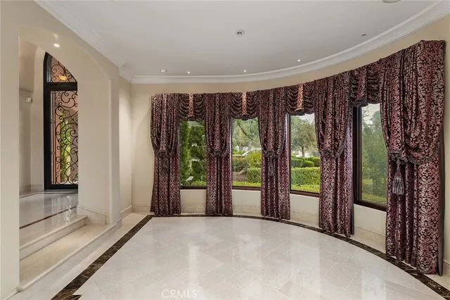 a view of an empty room with fireplace and a window