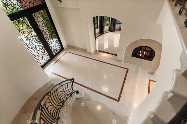 a view of a hallway with a fireplace and a large window