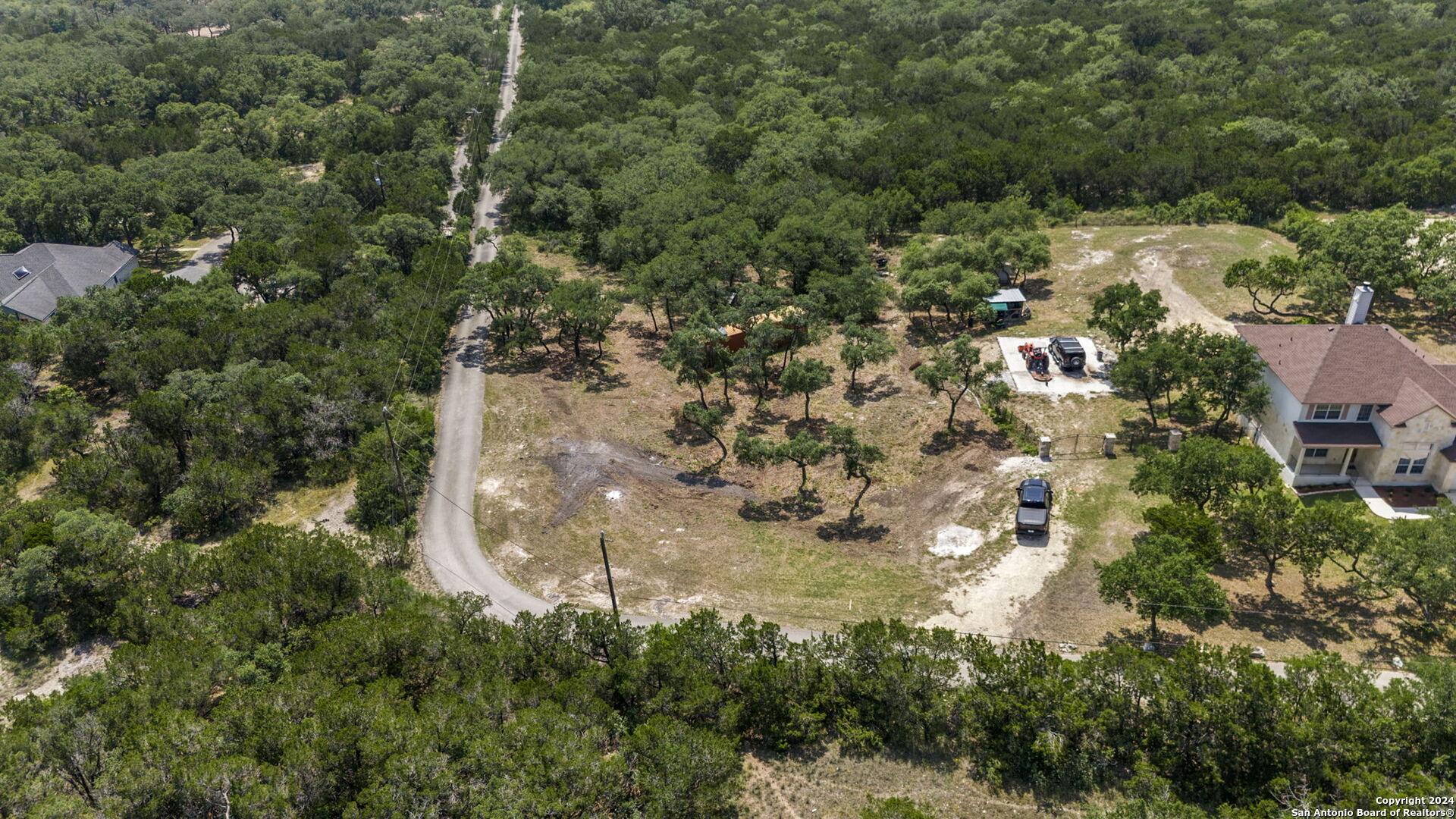 0 Bandera Road Helotes, TX 78023 - Photo 2 of 7 an aerial view of residential houses with outdoor space and trees all around