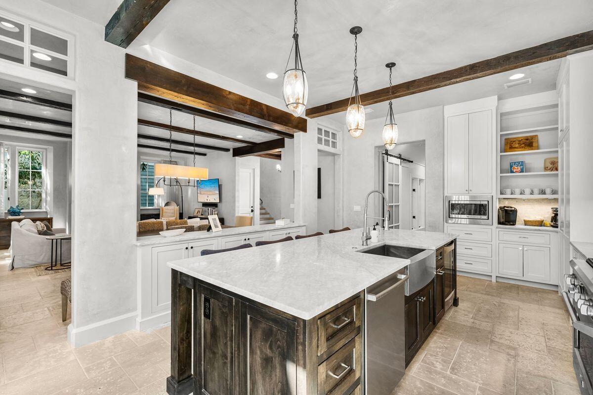 364 Boat Wright Way Watersound, FL 32461 - Photo 2 of 3 a kitchen that has a sink a stove and a table with chairs