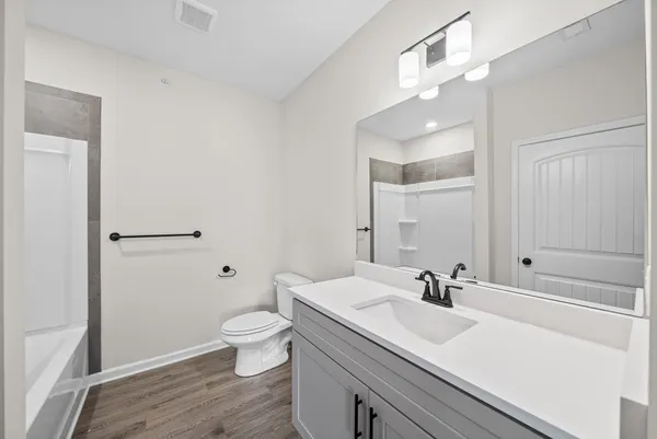 a view of bathroom with a sink mirror and toilet