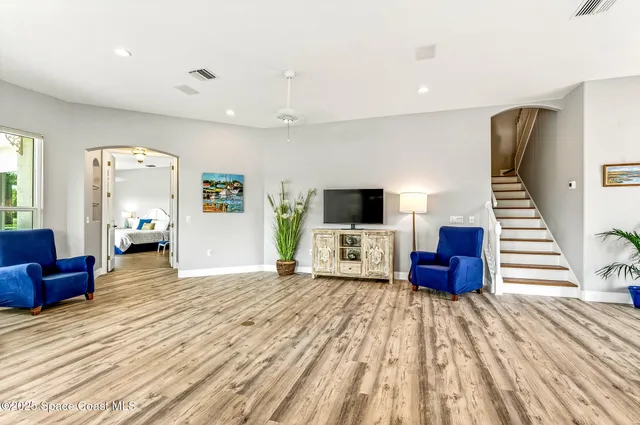 a view of a room with wooden floor and windows