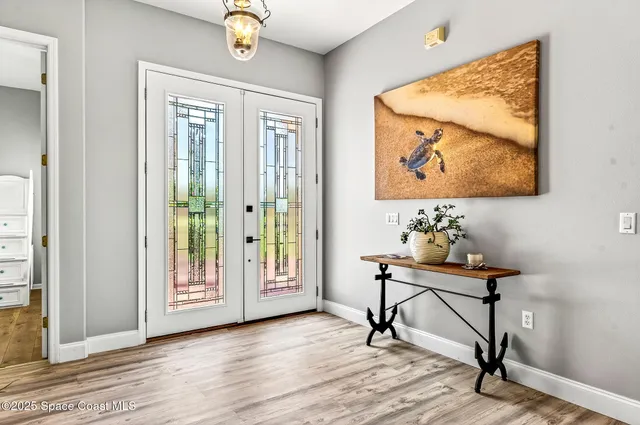 a living room with furniture and large windows