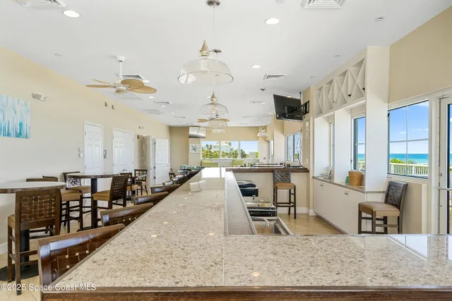 a view of a patio with chairs and a fire pit
