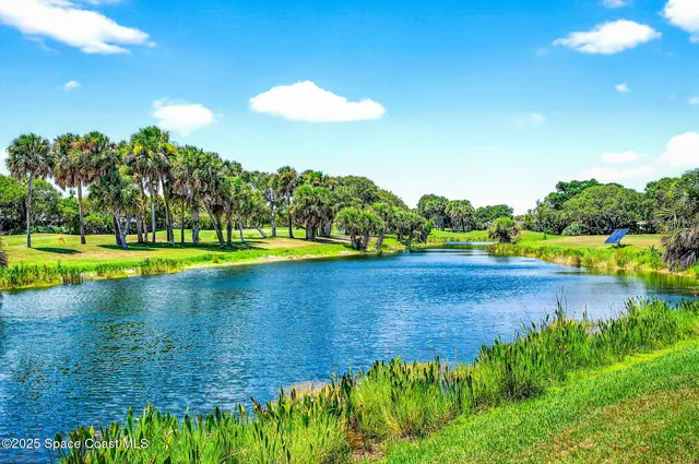 a view of a house with backyard sitting area and swimming pool
