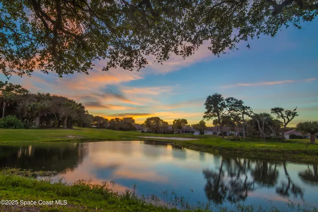 a view of a living room kitchen and a wooden floor