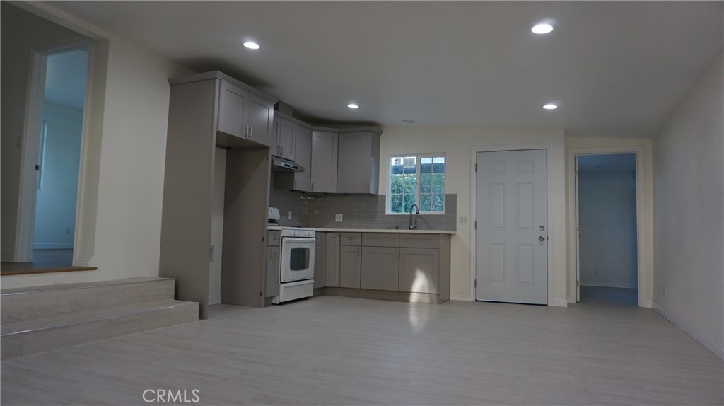a kitchen with a refrigerator and a sink