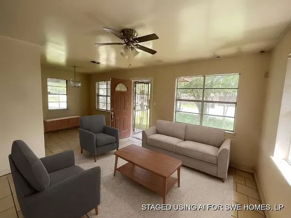 a living room with furniture and a large window