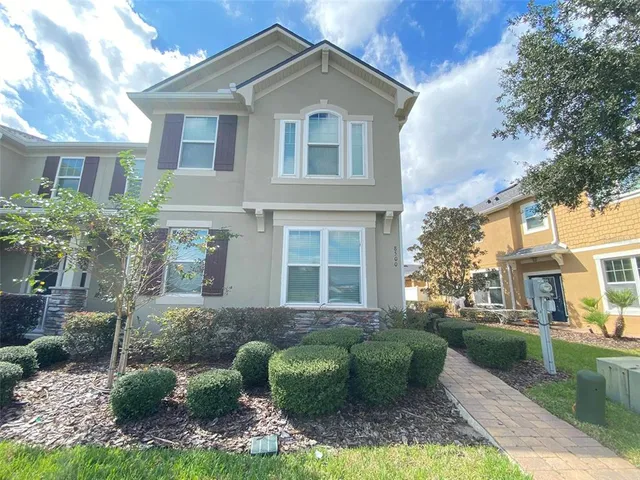 a front view of house with yard and green space