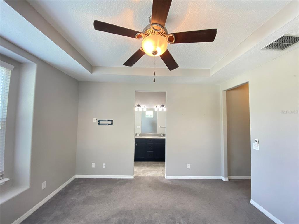8500 Iron Mountain Trail Windermere, FL 34786 - Photo 11 of 40 a view of a livingroom with a ceiling fan and window
