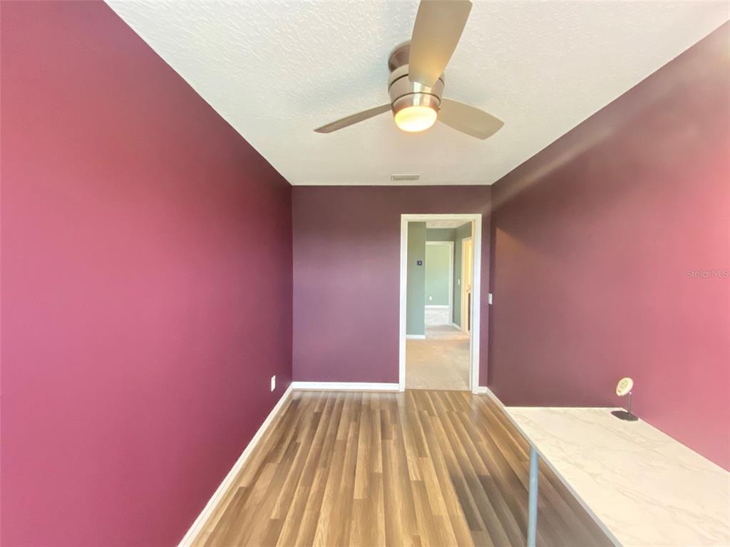 8500 Iron Mountain Trail Windermere, FL 34786 - Photo 24 of 40 a bedroom with a bed and a chandelier fan