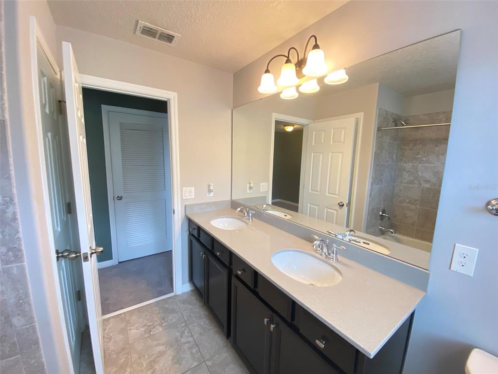 8500 Iron Mountain Trail Windermere, FL 34786 - Photo 30 of 40 a bathroom with a sink double vanity granite and a mirror