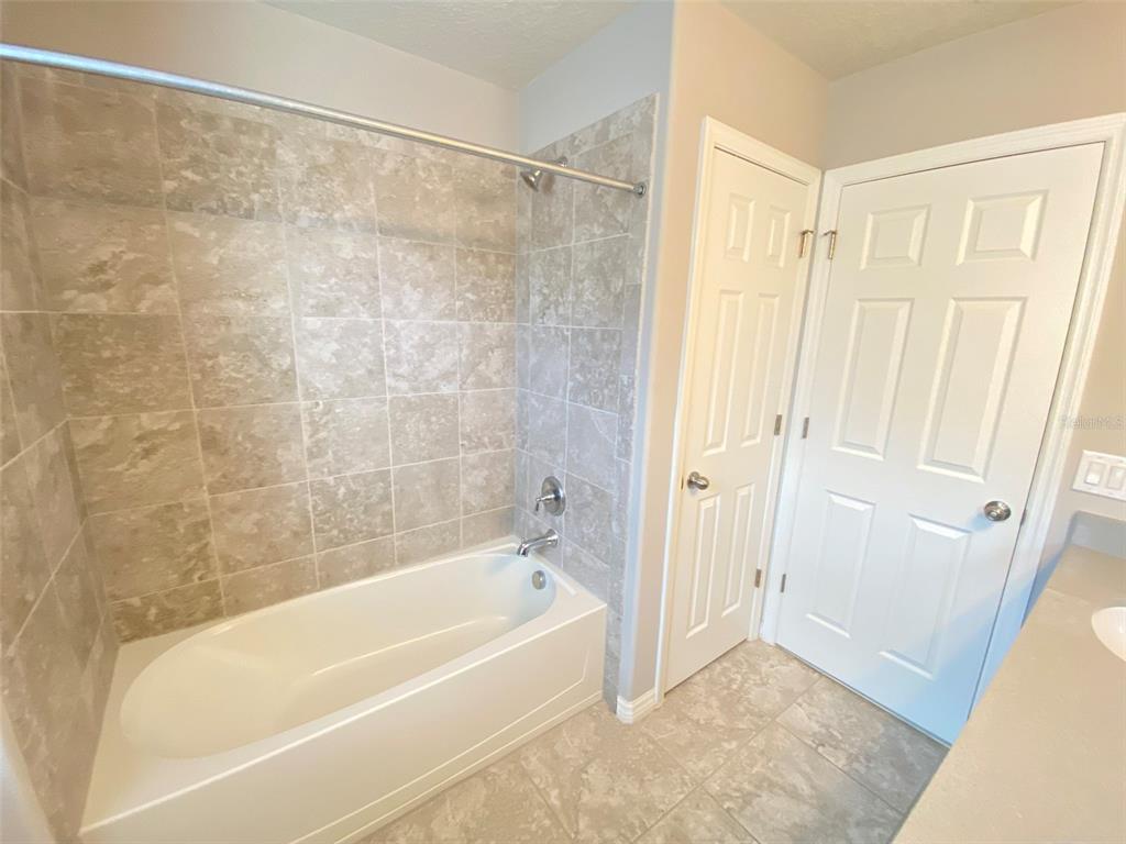 8500 Iron Mountain Trail Windermere, FL 34786 - Photo 31 of 40 a bathroom with a shower and a bath tub