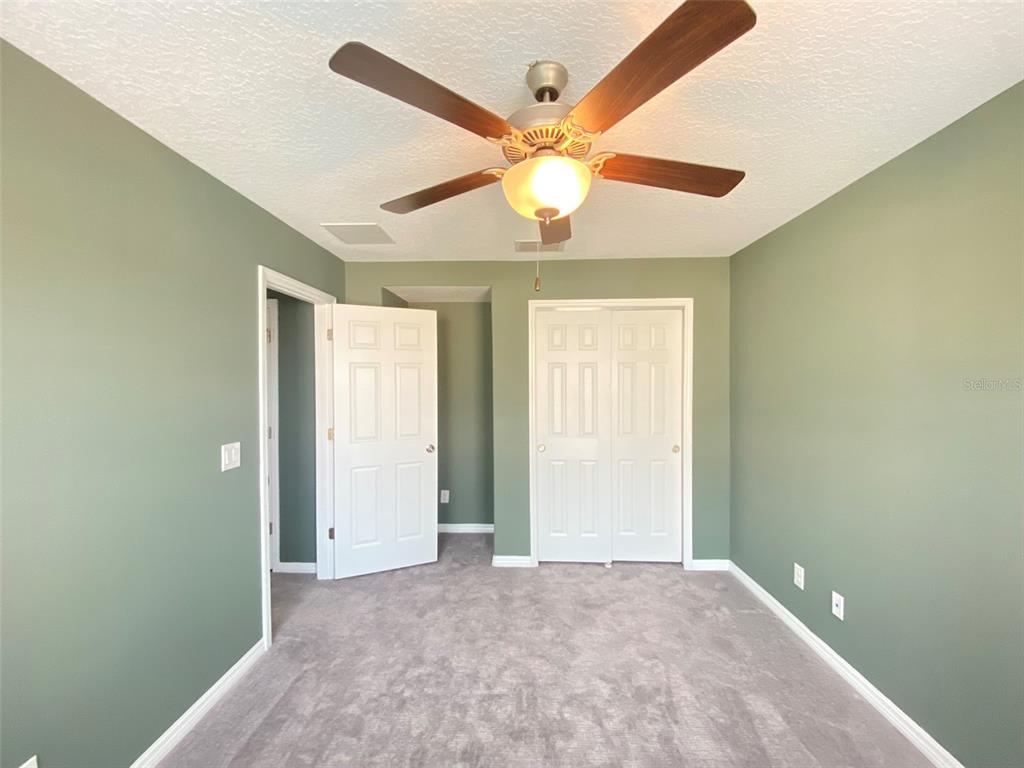 8500 Iron Mountain Trail Windermere, FL 34786 - Photo 34 of 40 an empty room with a window and a ceiling fan