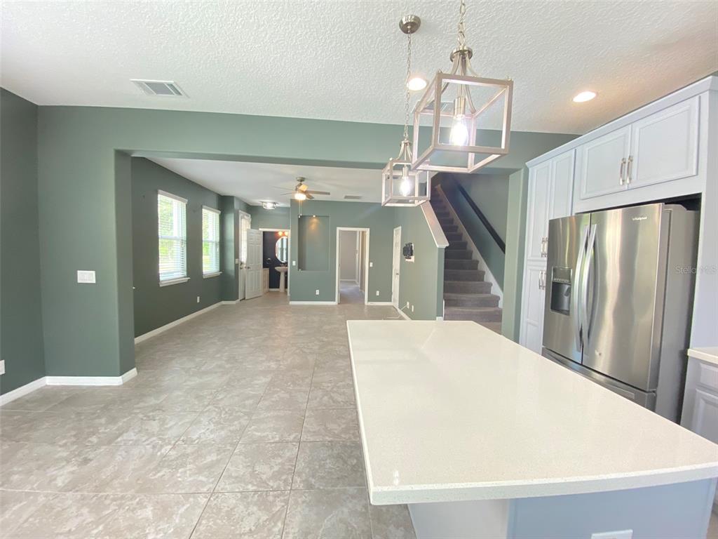 8500 Iron Mountain Trail Windermere, FL 34786 - Photo 4 of 40 a view of a hallway with staircase and kitchen view