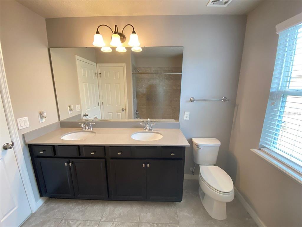 8500 Iron Mountain Trail Windermere, FL 34786 - Photo 9 of 40 a bathroom with a double vanity sink and a toilet