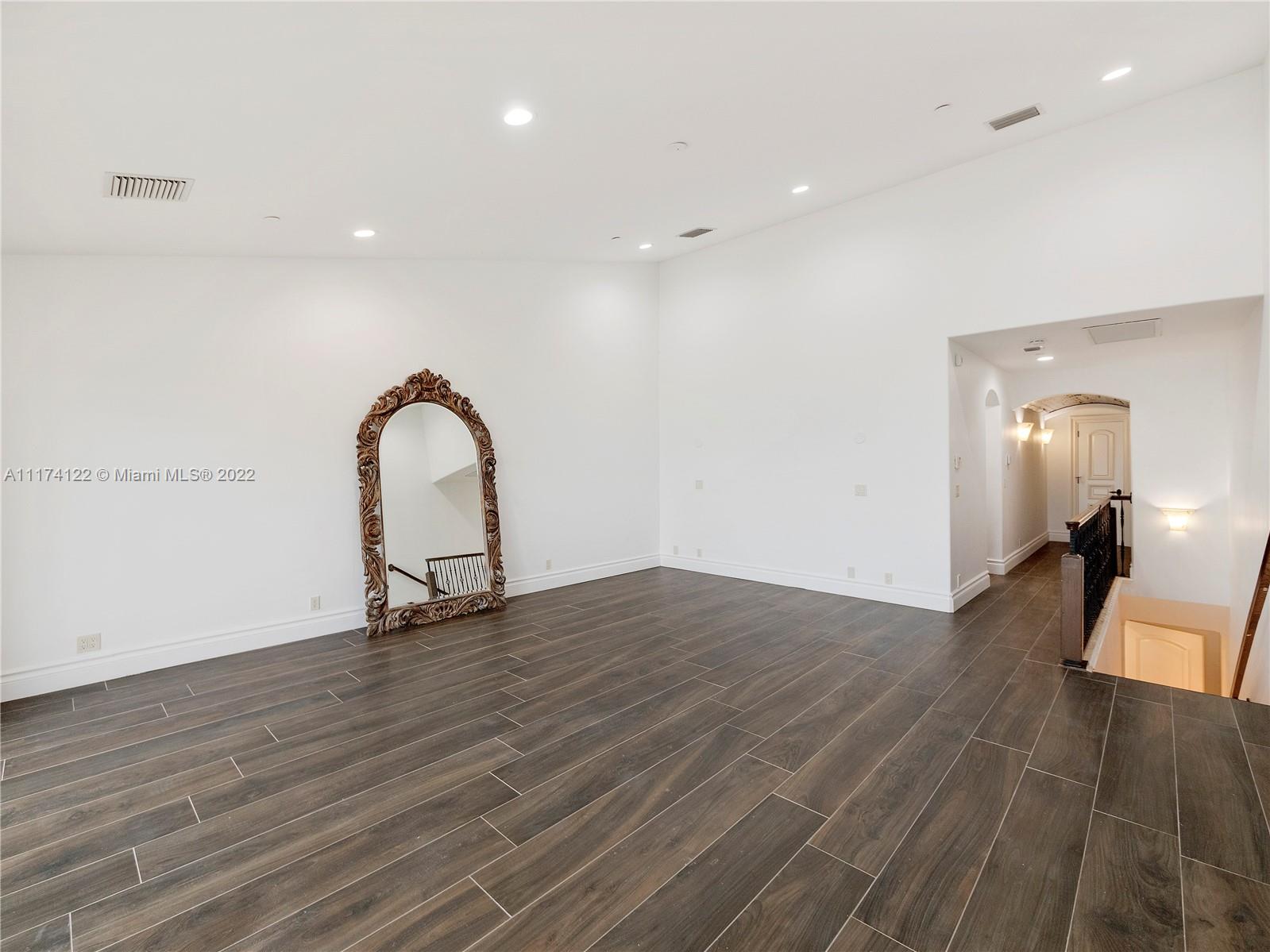 2050 Florida A1A, Unit 2 Jupiter, FL 33477 - Photo 11 of 22 a view of a room with wooden floor and stairs