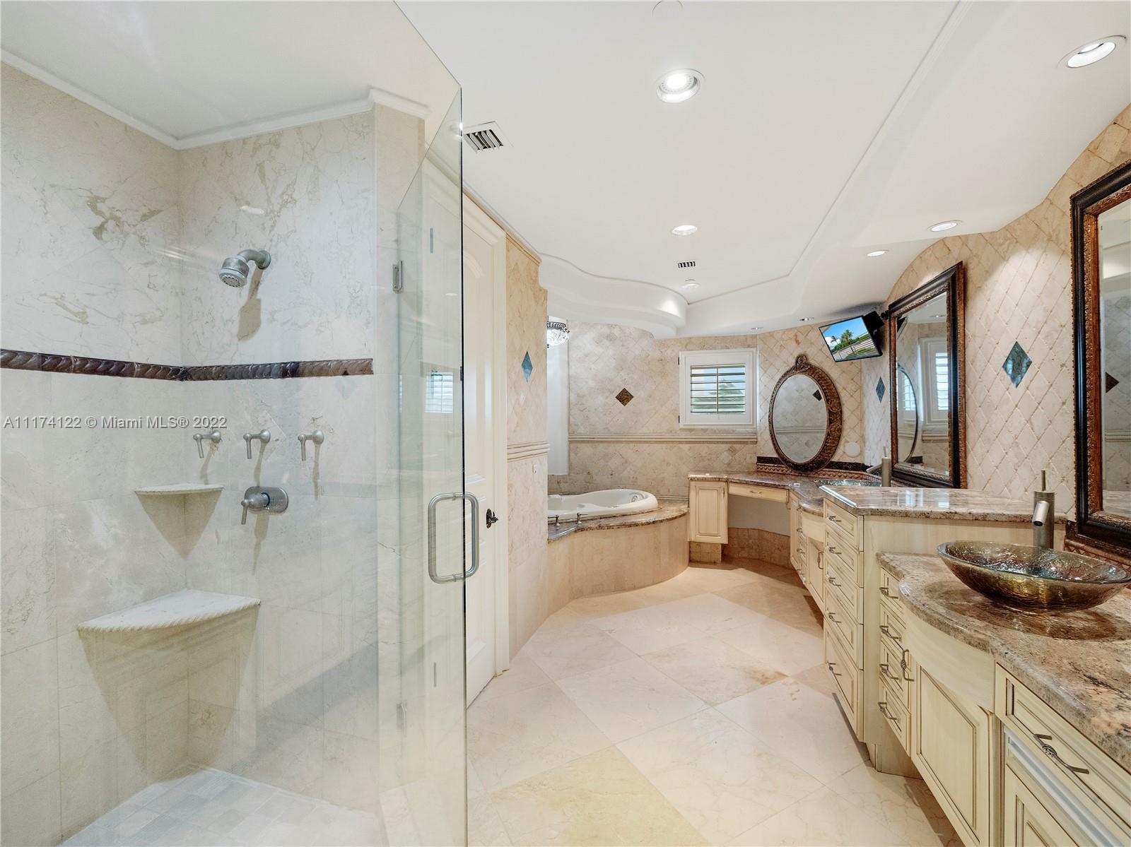 2050 Florida A1A, Unit 2 Jupiter, FL 33477 - Photo 12 of 22 a large bathroom with a double vanity sink a mirror and a shower