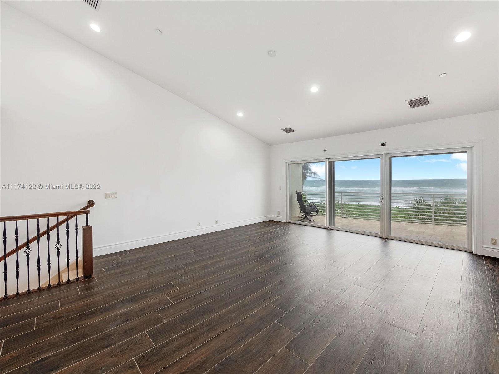 2050 Florida A1A, Unit 2 Jupiter, FL 33477 - Photo 13 of 22 a view of an empty room with wooden floor and a window
