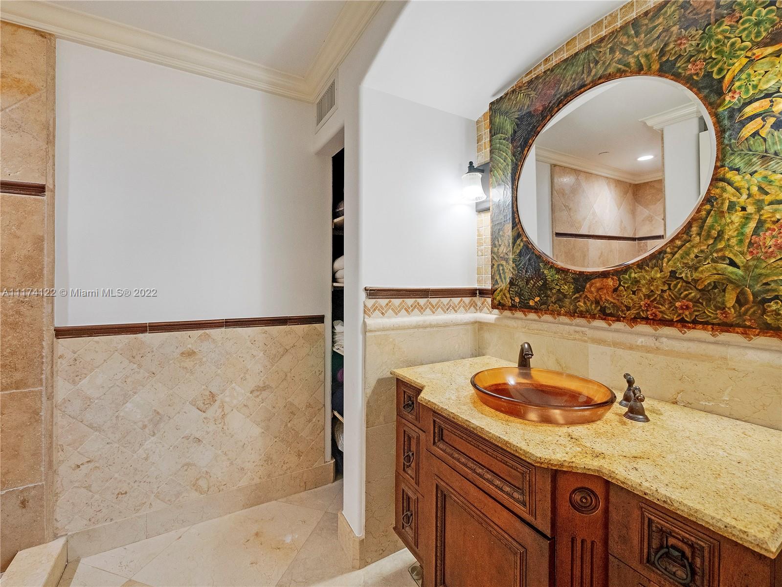 2050 Florida A1A, Unit 2 Jupiter, FL 33477 - Photo 14 of 22 a bathroom with a granite countertop sink and a mirror