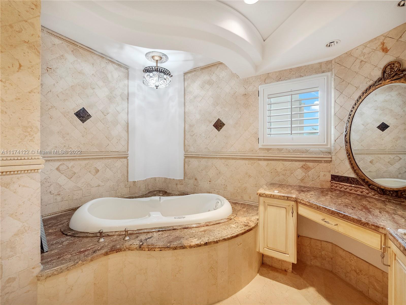 2050 Florida A1A, Unit 2 Jupiter, FL 33477 - Photo 16 of 22 a bathroom with a sink and a mirror