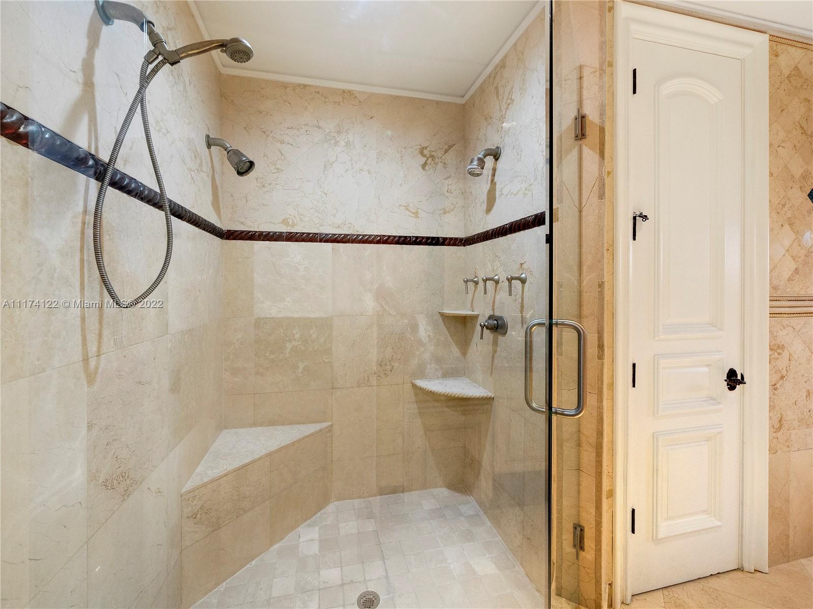 2050 Florida A1A, Unit 2 Jupiter, FL 33477 - Photo 18 of 22 a bathroom that has a glass shower door