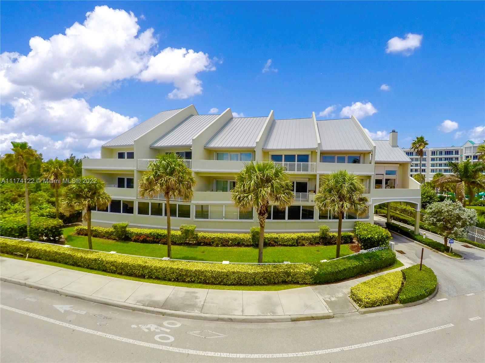 2050 Florida A1A, Unit 2 Jupiter, FL 33477 - Photo 21 of 22 a front view of a house with a yard