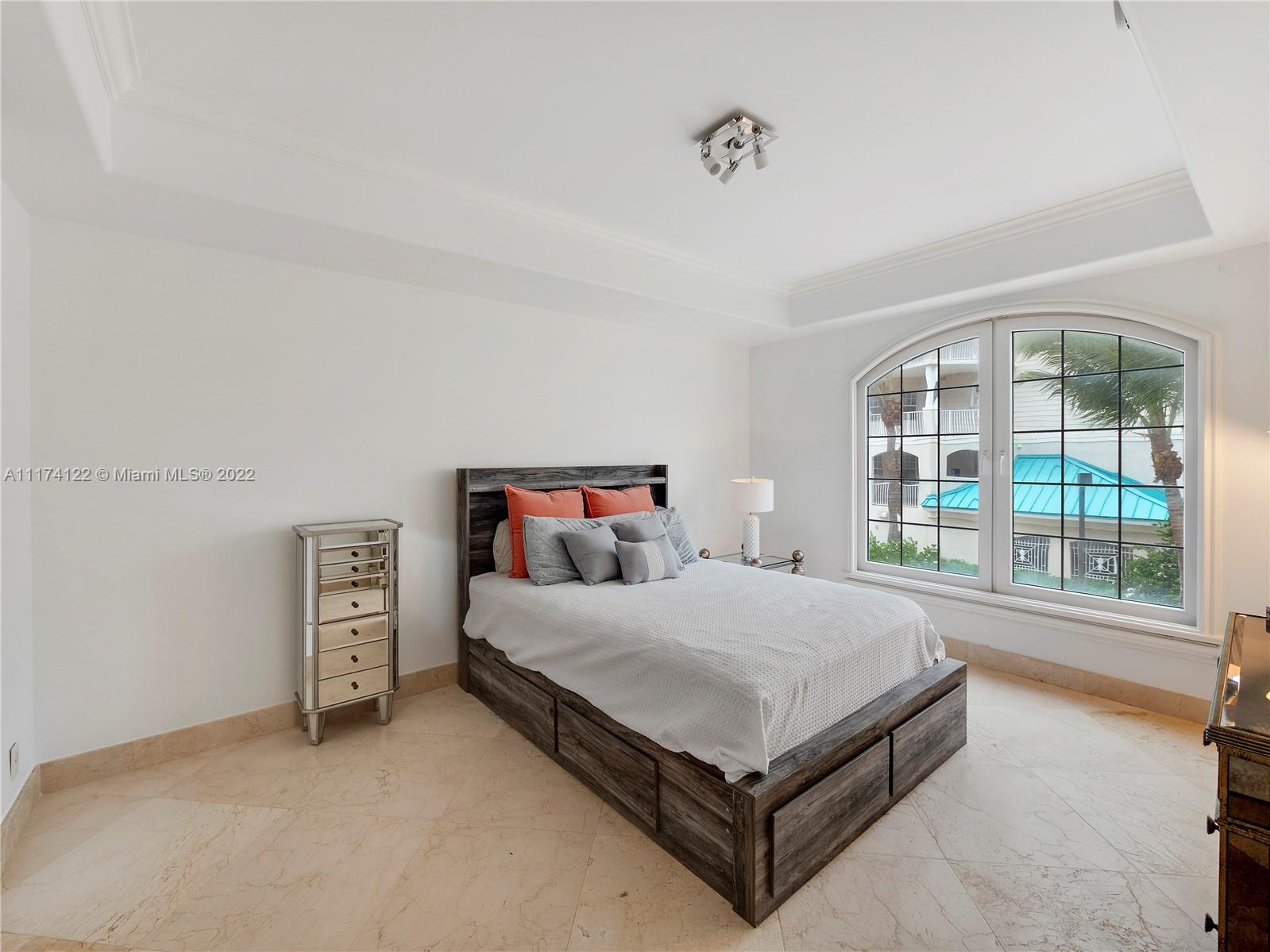 2050 Florida A1A, Unit 2 Jupiter, FL 33477 - Photo 10 of 22 a bedroom with a bed and a large window