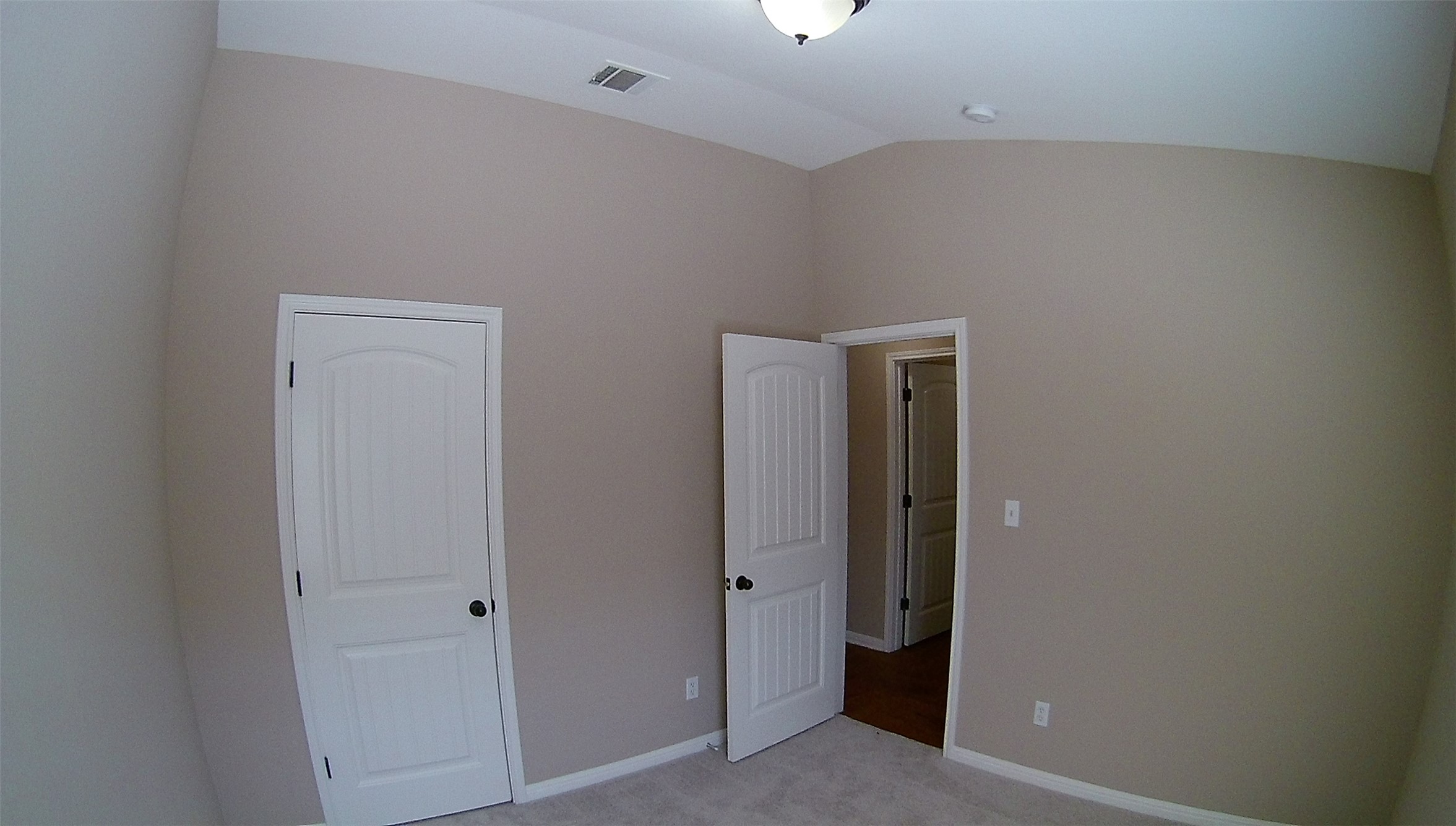 3304 Wickham Lane Austin, TX 78725 - Photo 10 of 13 Unfurnished bedroom with light colored carpet and lofted ceiling
