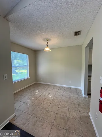 a view of an empty room with a window