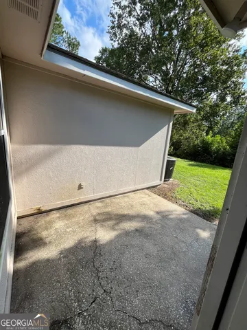 a view of a backyard space with wooden fence