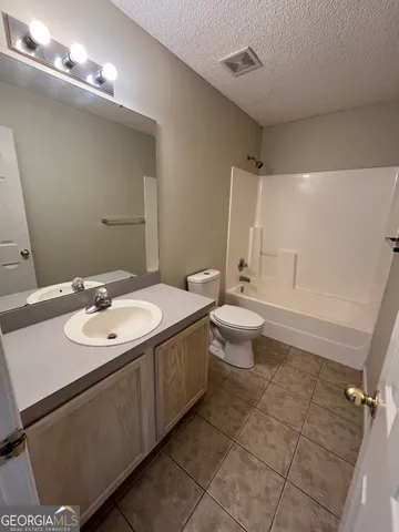 a bathroom with a sink mirror and toilet