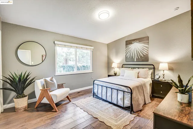 a bedroom with a bed lamp closet and window