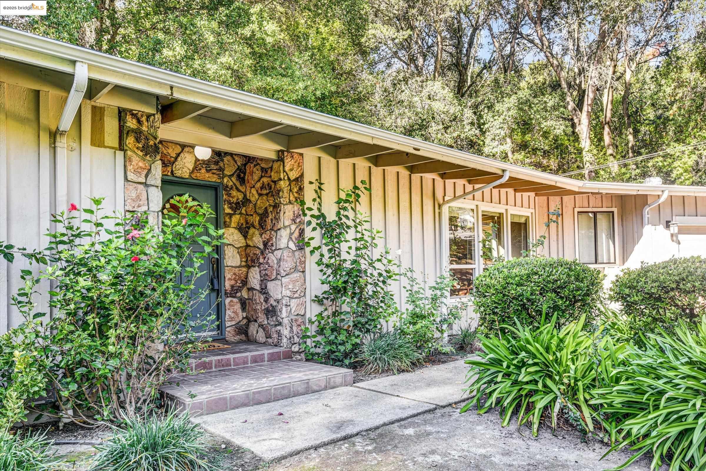 7 St Stephens Drive Orinda, CA 94563 - Photo 4 of 27 a front view of a house with garden