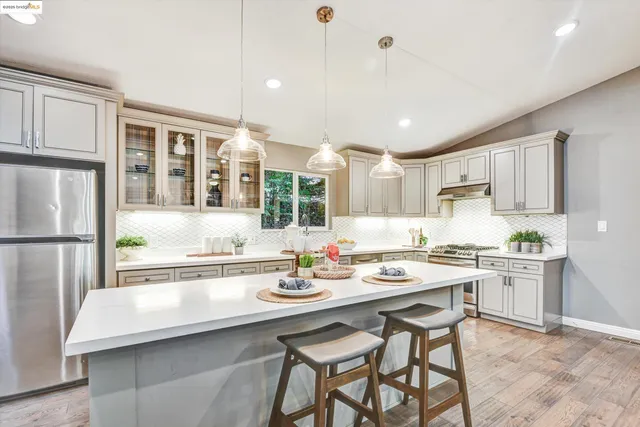 a kitchen with a sink stainless steel appliances and cabinets