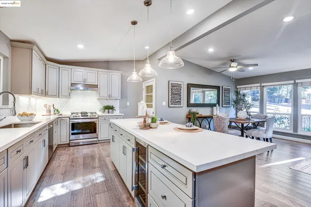 a kitchen with a stove sink and cabinets