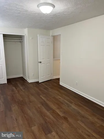 a view of an empty room and wooden floor